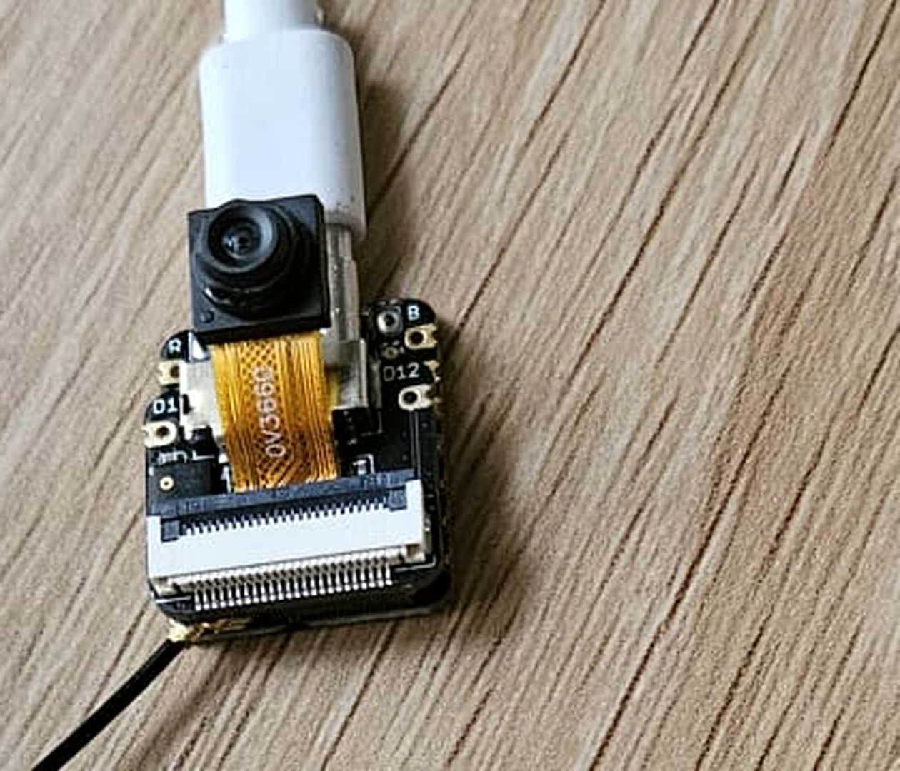 Macro of the camera module — the orange flex cable reads OV3660